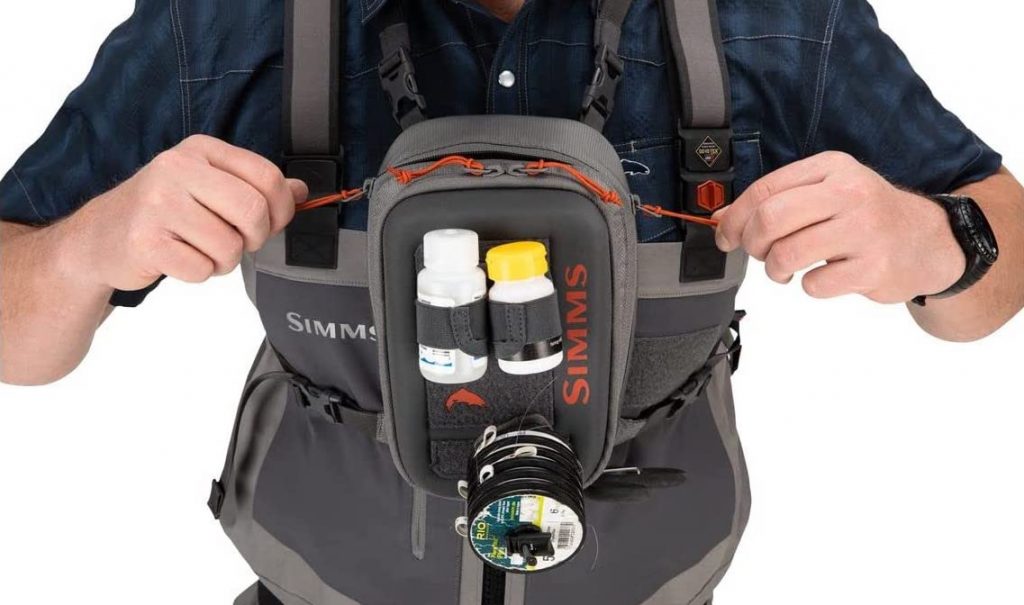 Simms Freestone Water Resistant Outdoor Chest Bag - Front View Closed Simms Freestone Water Resistant Outdoor Chest Bag with Pockets | Simms Freestone Water Resistant Outdoor Chest Bag
The exterior features a secured tippet caddy and loop velcro for wet fly storage. It also has exterior magnetic docking stations for nippers or mitten clamps.