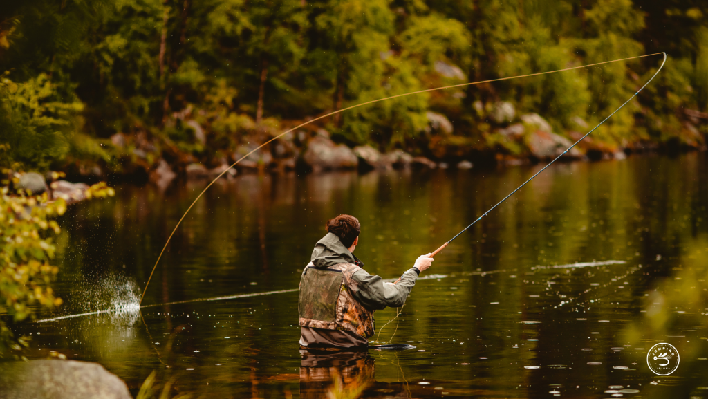 Fly fisherman in stream with chest waders | Jumping Rise